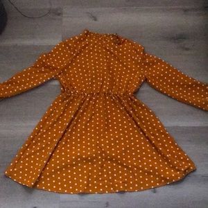 This is an orange polka dot dress that is super unique and absolutely adorable